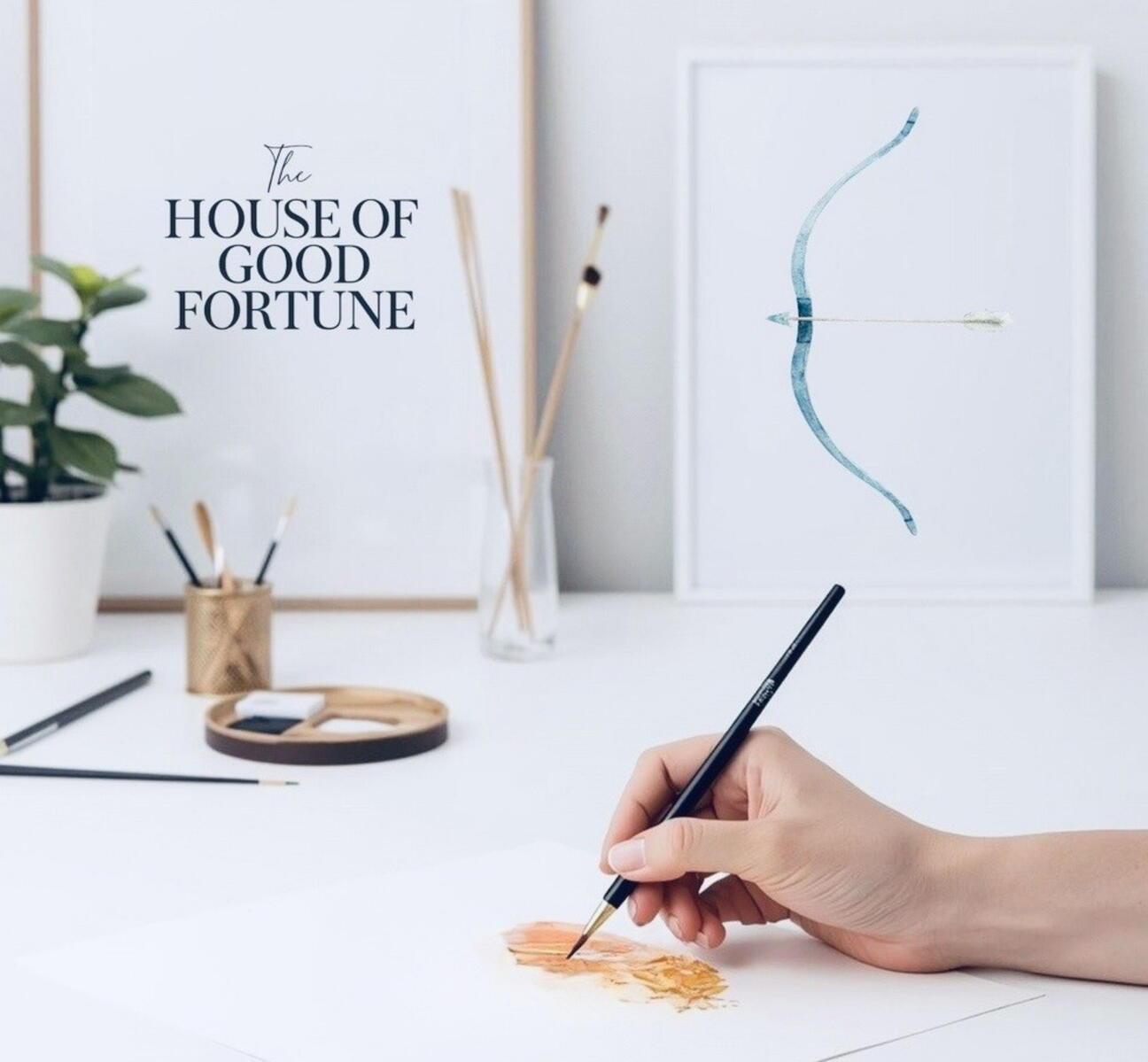 An artist painting a card for The House of Good Fortune